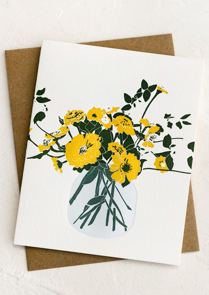 A letterpress card with image of yellow zinnias in glass vase.