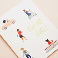 2: A greeting card with little illustrations of women in motion and the words "you go girl" in gold foil.