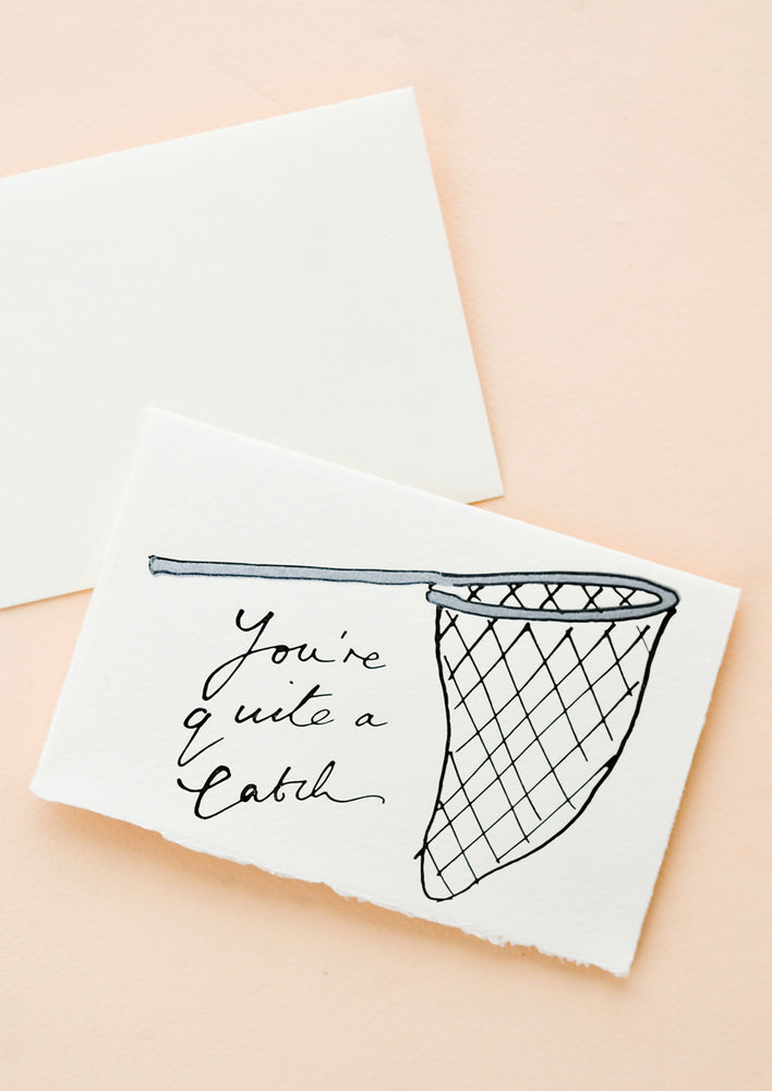 A hand-painted greeting card with image of a butterfly net, cursive text reads "You're Quite A Catch".