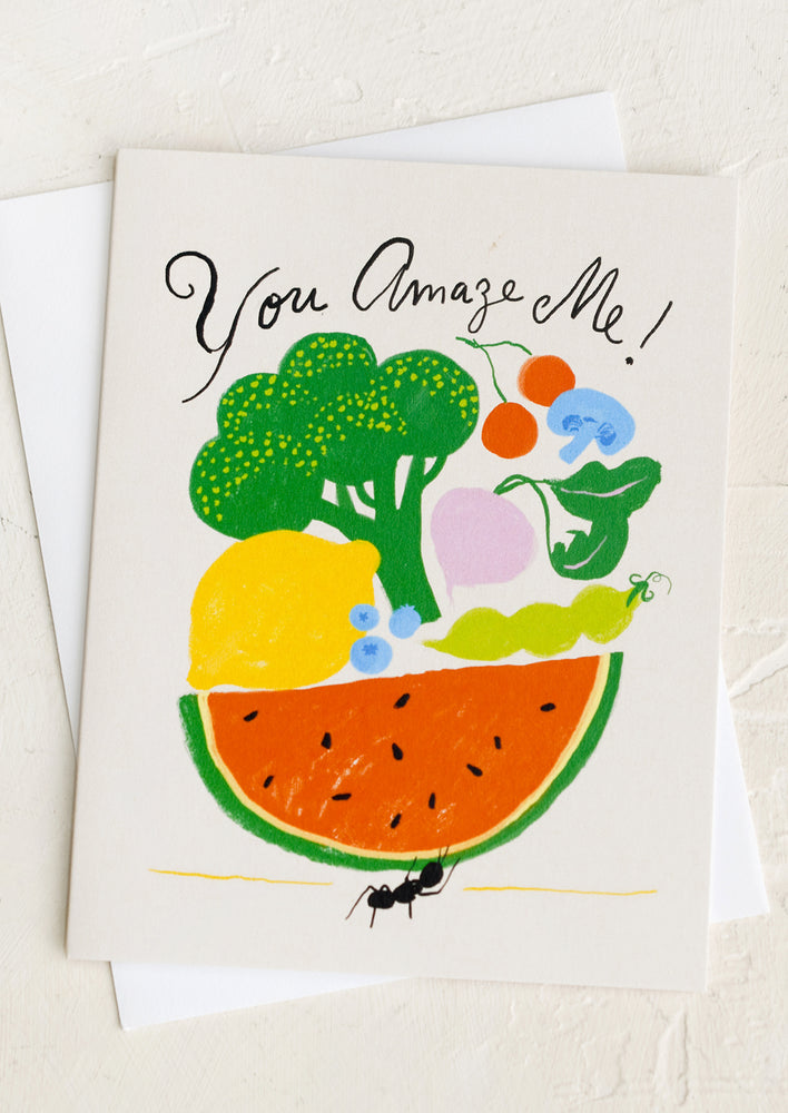 1: A greeting card with illustration of an ant holding up lots of fruit, text reads "You amaze me!".
