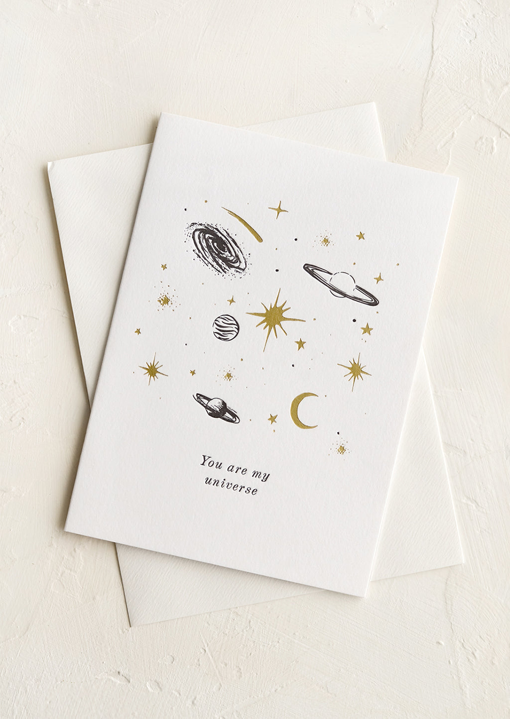 1: A greeting card with black and gold planets and text reading "You are my universe".