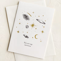 1: A greeting card with black and gold planets and text reading "You are my universe".