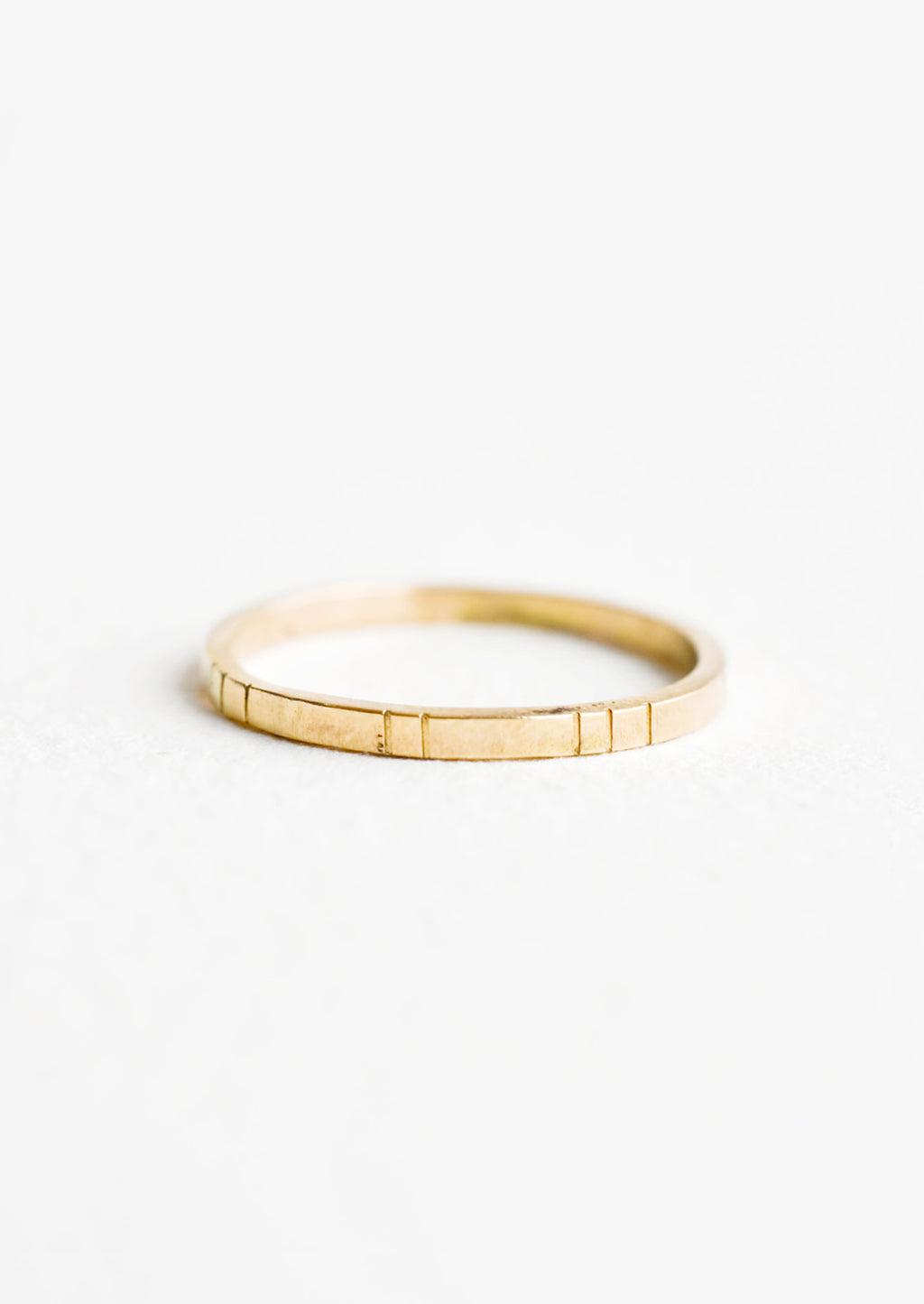 1: Yellow gold ring, medium weight band with etched decorative lines.