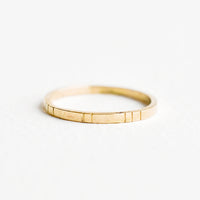 1: Yellow gold ring, medium weight band with etched decorative lines.