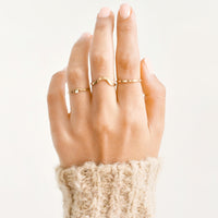 2: Model shot of hand wearing three different styles of rings.