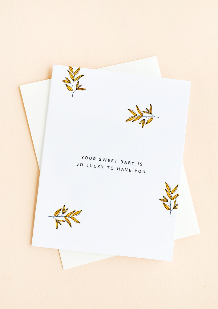 1: A greeting card with scattered leaf print and small caps text reading "Your sweet baby is so lucky to have you"