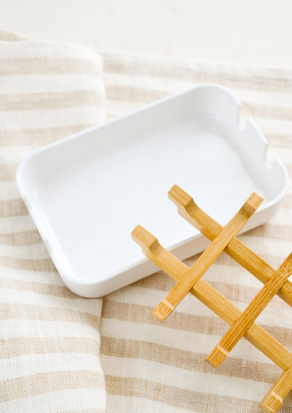 3: A white soap dish with built-in removable bamboo drainage tray.