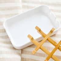 3: A white soap dish with built-in removable bamboo drainage tray.