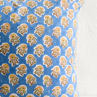 2: A block printed throw pillow in blue and yellow floral.