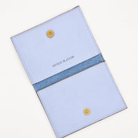 2: Slim blue leather wallet with two interior slip pockets that folds closed with a snap, shown open in 