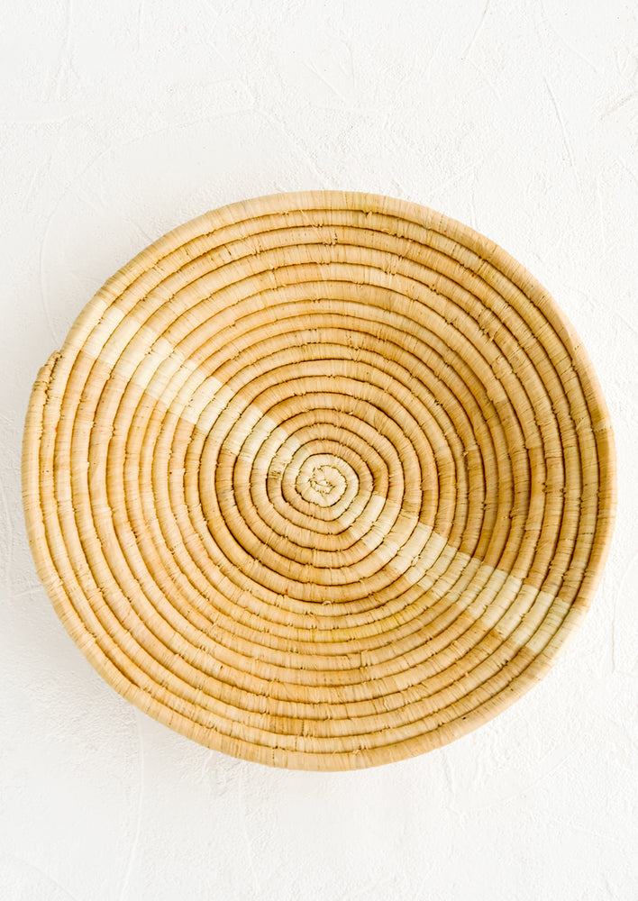 Tan / Natural: Tan woven raffia bowl with natural streak across middle