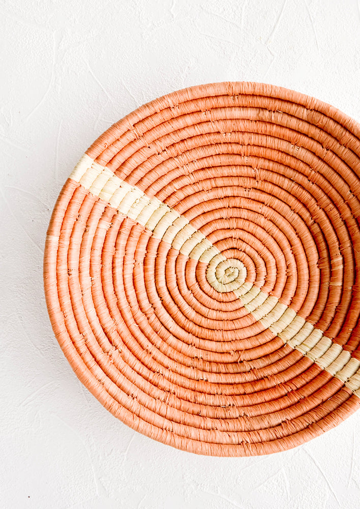 Peach / Ivory: Peach woven raffia bowl with natural streak across middle